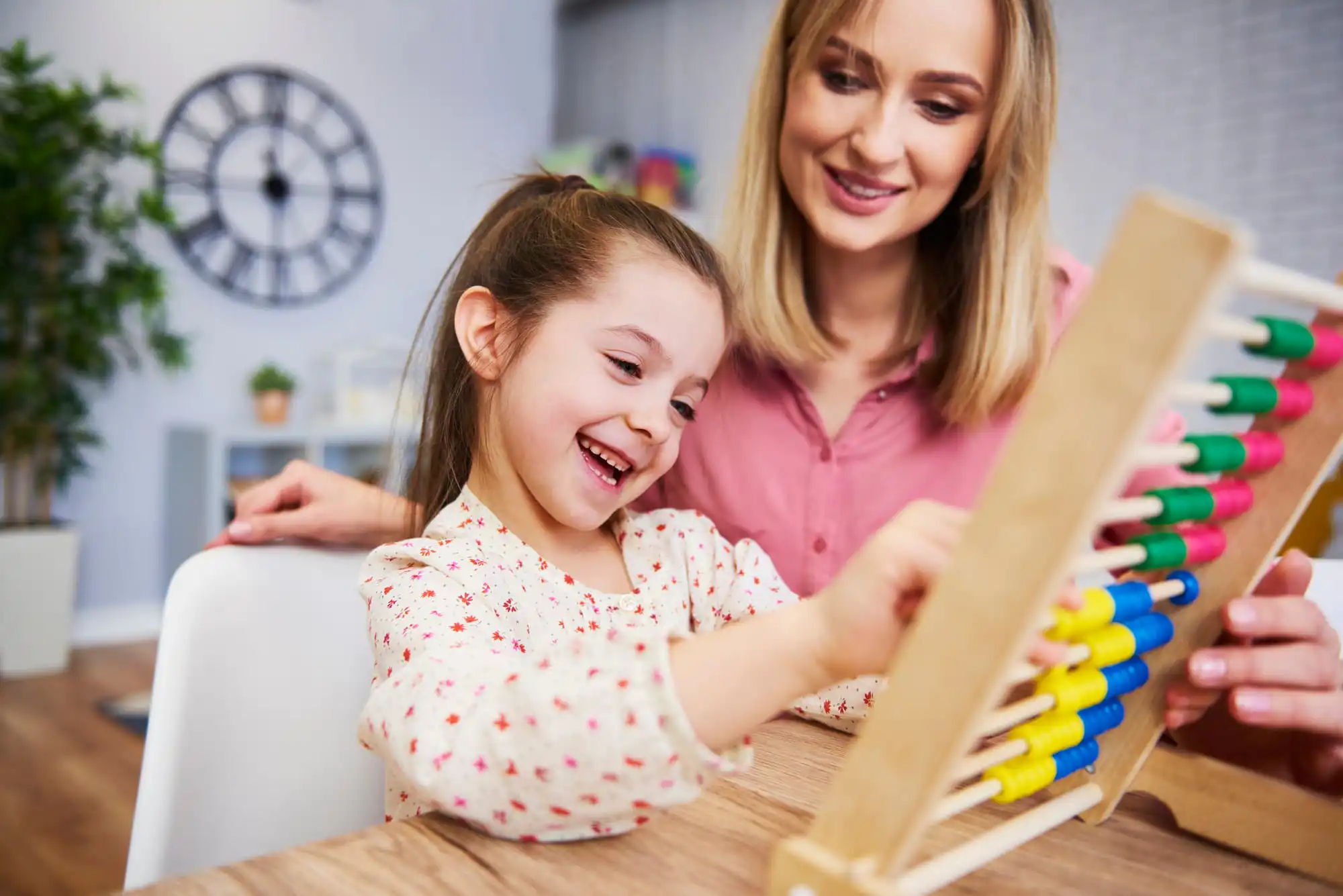 aba therapist teaching a child how to use abacus