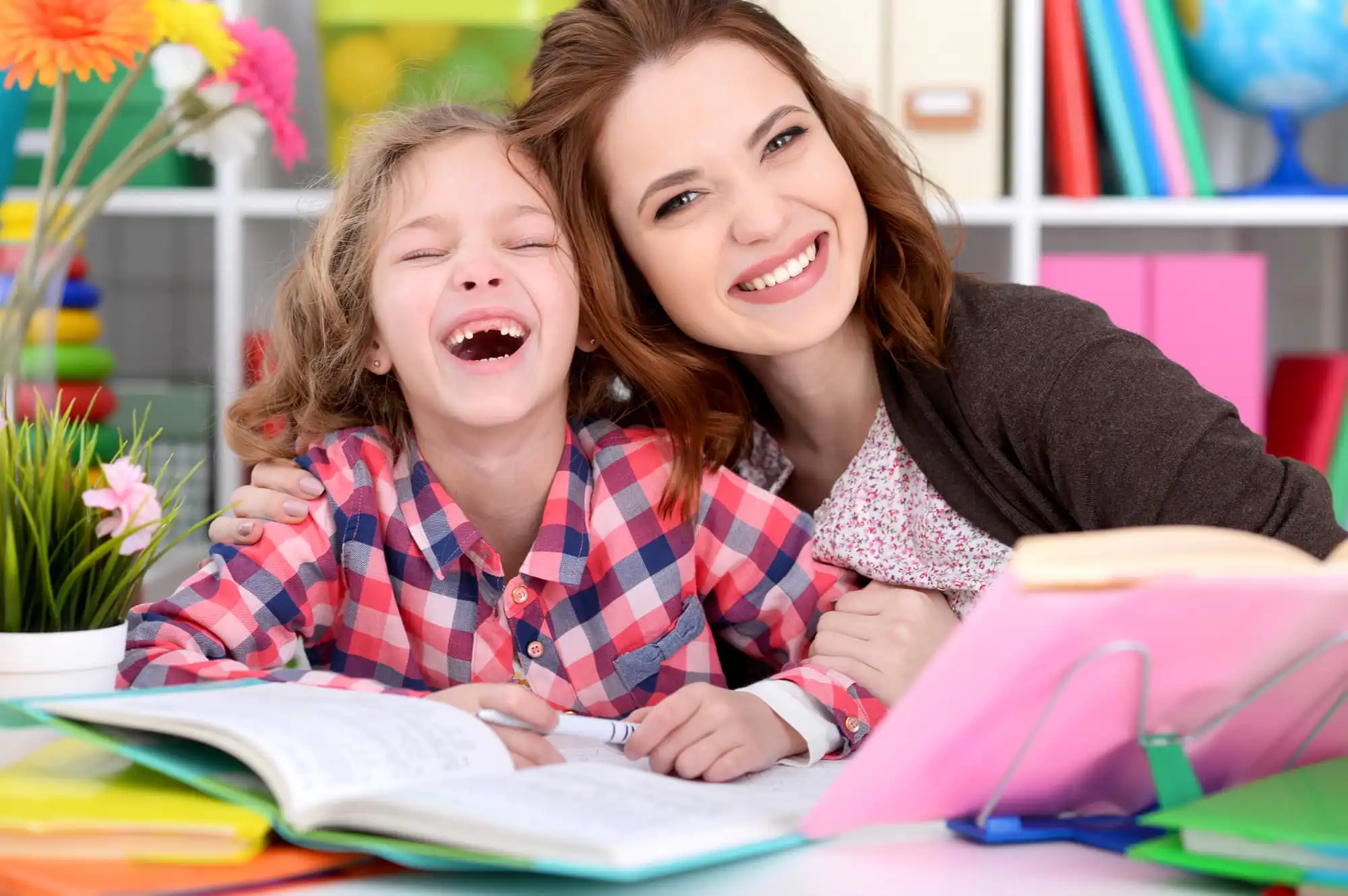 a girl smiling widely with her aba therapist